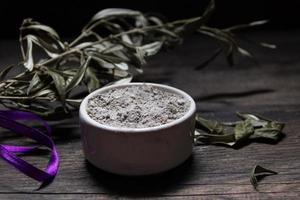 bowl with ashes and olive branch. ash wednesday concept photo