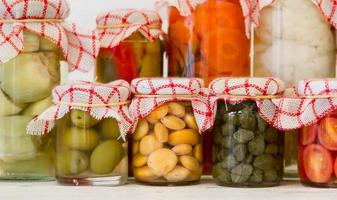 variety of jars with organic vegetable pickles photo