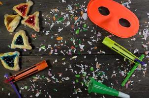 Jewish carnival concept Haman ears, masks, noisemakers, confetti photo