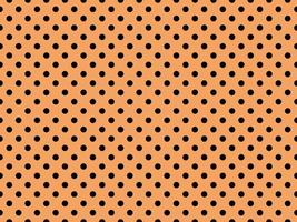 black polka dots over sandy brown background photo