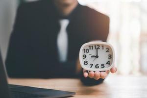 clock on businessman hand, time management concept,effective business planning,time management in the organization,Agreement and solution,end of the deal ,profitable use of time photo