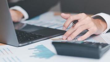 Business people read business statistics chart reports, to analyze and improve corporate strategy, manage financial and marketing documents, update annual budget accounts, company growth data. photo