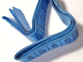 Isolated white photo of a sewing meter or fabric meter in blue.