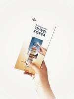 Jakarta, Indonesia in May 2022. A hand is holding a welcome guide book for travelers on vacation on Korea photo