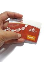 West Java, Indonesia on July 2022. Isolated photo of a hand holding a loyalty card, Alfa Gift Card.