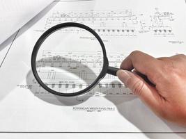 A magnifying glass is often used to view and magnify detailed shop drawings photo