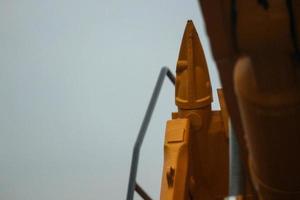 Close up detailed components of the yellow excavator photo
