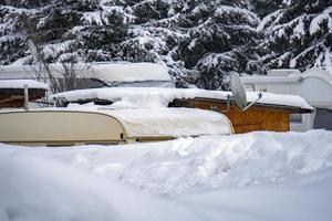 rv trailer caravan roulotte covered by white snow photo