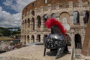 metallic gladiator helm on rome coliseum background photo