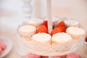 Delicious sweets arranged on the table for wedding reception photo