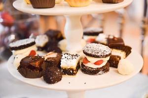 Delicious sweets arranged on the table for wedding reception photo