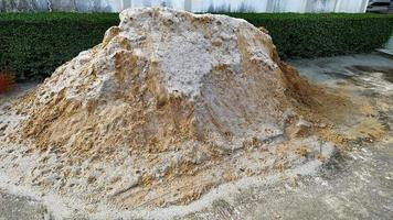 Pile of sand on cement floor for construction work. photo