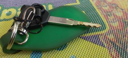 Motorcycle key with a green keychain photo