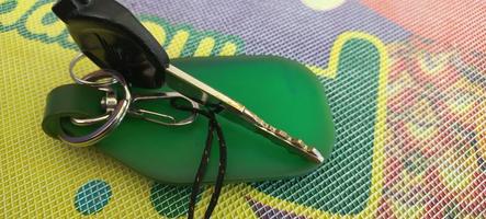 Motorcycle key with a green keychain photo