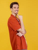 Portrait of young handsome man looking confident at the camera with smile with crossed arms and hand raised on chin over isolated background photo