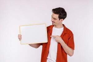 Portrait of happy man showing blank signboard on isolated white background photo