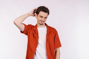 Portrait of thinking man surrounded by question mark on isolated background photo