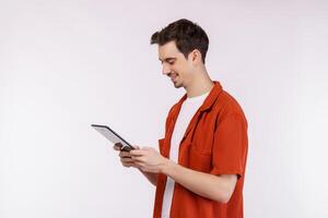 Portrait of attractive cheerful man using device app searching web isolated over white color background photo