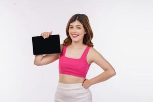 Portrait of excited young woman holding tablet mock up isolated over white background photo