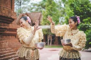 Portrait beautiful women in Songkran festival with Thai Traditional costume photo