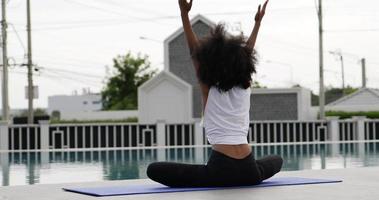lento . el yoga es hecho por mujeres africanas en la piscina video