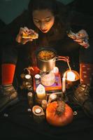 Close up woman witch brewing medicine in cauldron portrait picture photo