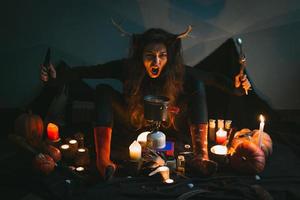 Close up female shaman with knife and spoon roaring portrait picture photo