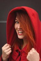 Close up joyful lady wearing red coat with hood portrait picture photo