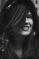 Close up smiling lady with fairy lights in hair monochrome portrait picture photo