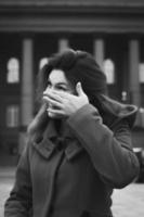 Close up woman wiping face on street monochrome portrait picture photo