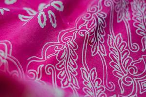 Bakcground Texture pink batik fabric and white motif photo