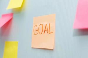 Goal. Post It. many colored sheets sticky note paper on white board background in home office, business meeting, brainstorming, creative idea, digital online marketing and business financial concept photo