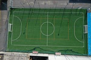 soccer field between houses aerial drone photo