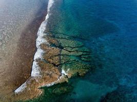 Pacific ocean reef waves Polynesia Cook Island tropical paradise aerial view photo