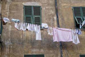 clothes hanging outside house drying to the sun photo