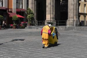 MEXICO CITY, MEXICO - NOVEMBER 5 2017 - Old dustman in Saint Domingo Place photo