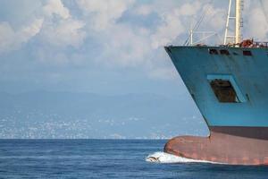 dolphin jumping over ship prow photo