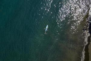 Canoe kayak paddling in French Polynesia Tahiti Island tropical paradise aerial view photo