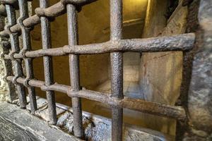 medieval cellar prison iron bars grate photo