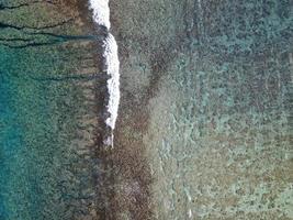 Pacific ocean reef waves Polynesia Cook Island tropical paradise aerial view photo