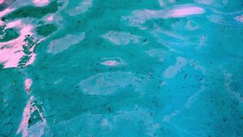 Top view of texture of clean blue surface of pool water with light reflections. Slow motion net, sunlight refraction, water, background. Water caustic background. video