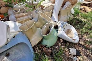 Many old abandoned ceramic toilet wc sinker photo