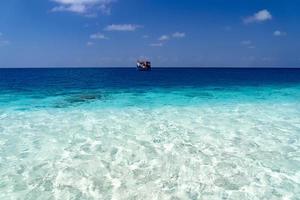 maldivian dhoni boat in blue ocean photo