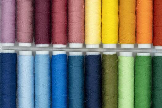 spool of thread many of different colors isolated on white photo