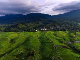 Beautiful morning view from Panorama View of Indonesian rice fields with mountain photo