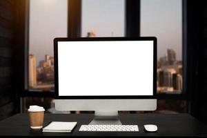 workspace with computer, laptop, office supplies, and coffee cup, smartphone, and tablet at office. desk work concept. photo