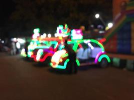 Abstract blurred of decorative pedicab in city square with bokeh light background. photo