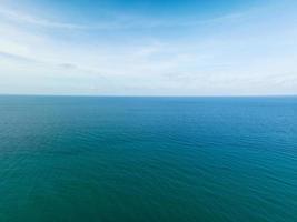 Aerial view of a blue sea surface water texture background and sun reflections Aerial flying drone view Waves water surface texture on sunny tropical ocean photo