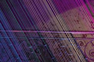 A flight of stairs with stretched threads illuminated with all the colors of the rainbow. Neon light, abstract photo