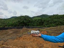 someone's hand will fly the drone photo